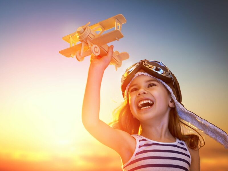 Dreams,of,flight!,child,playing,with,toy,airplane,against,the